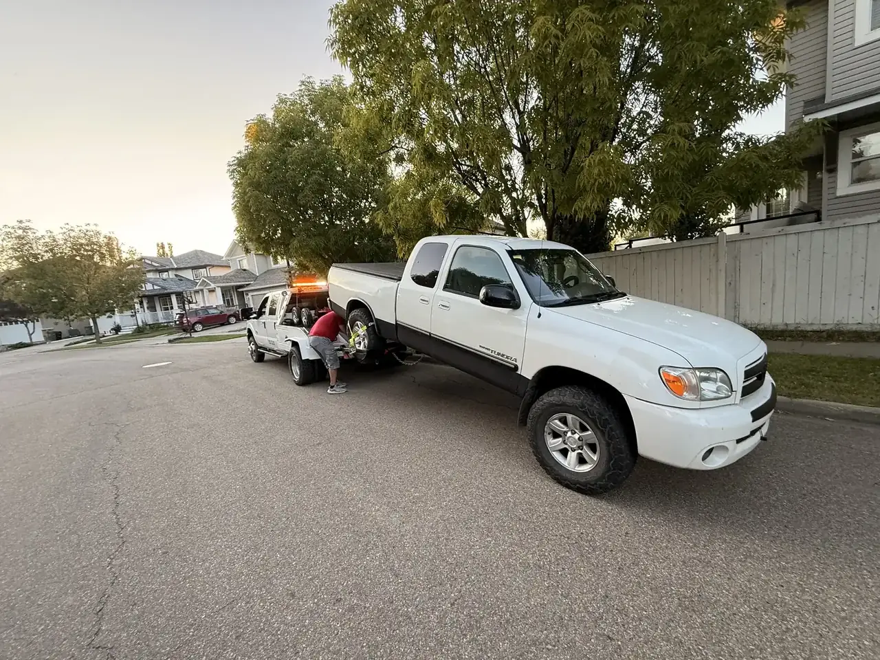 Ironline operator securing a 4x4 pickup truck to the tow truck in Edmonton