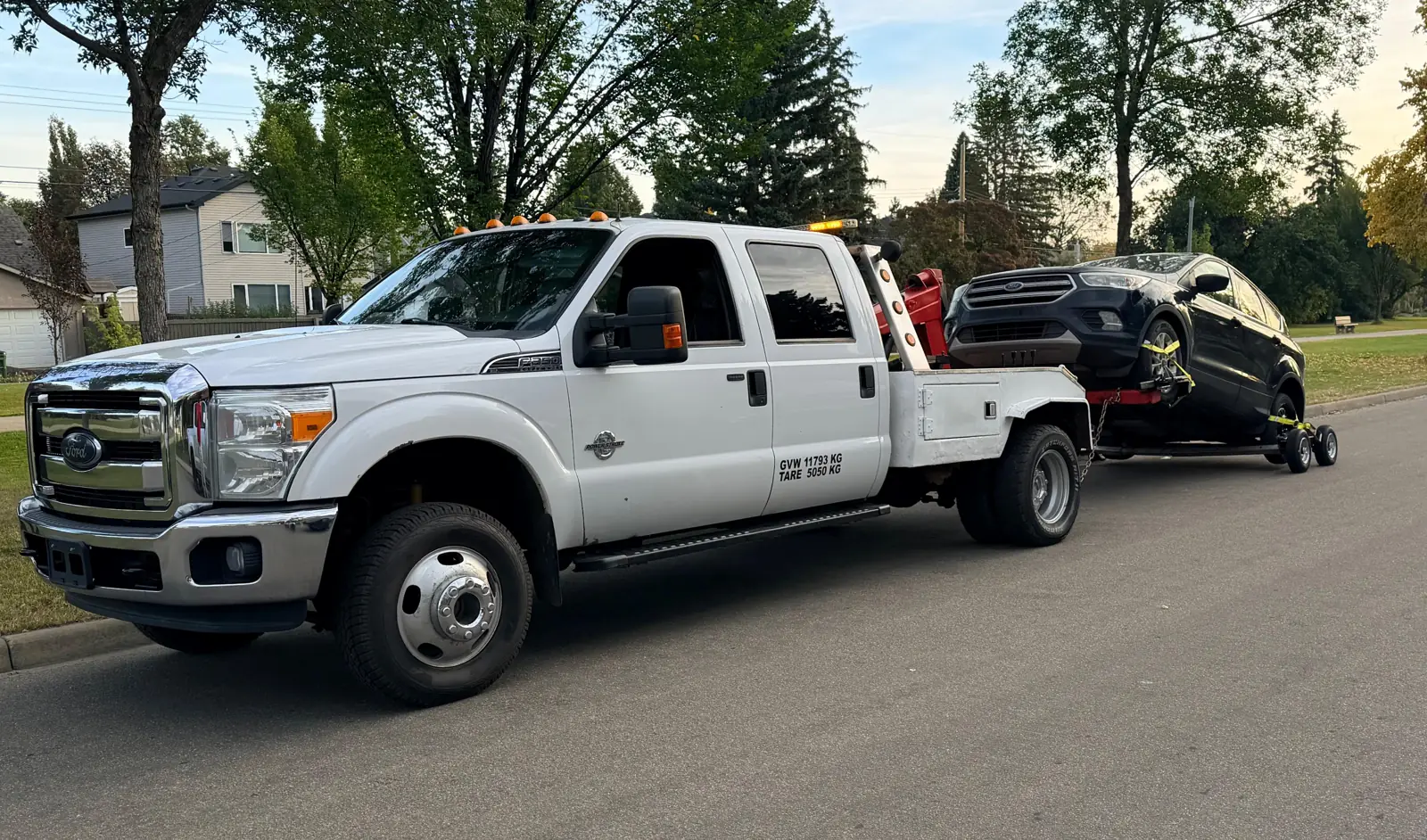 Ironline tow truck towing an SUV on dollies in Edmonton